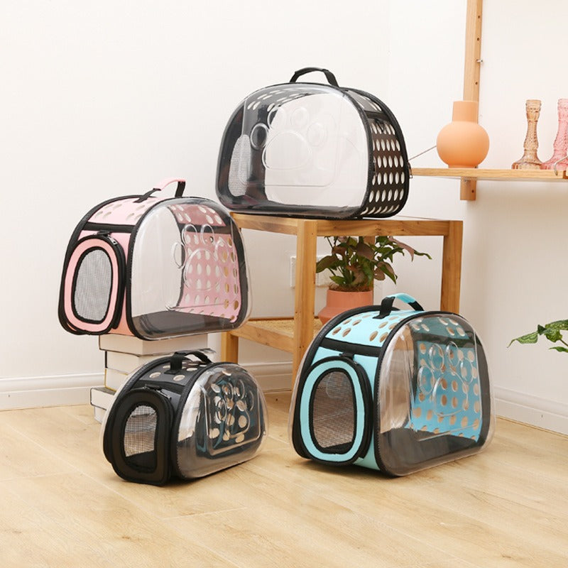Clear pet carriers with black frames on a wooden floor.