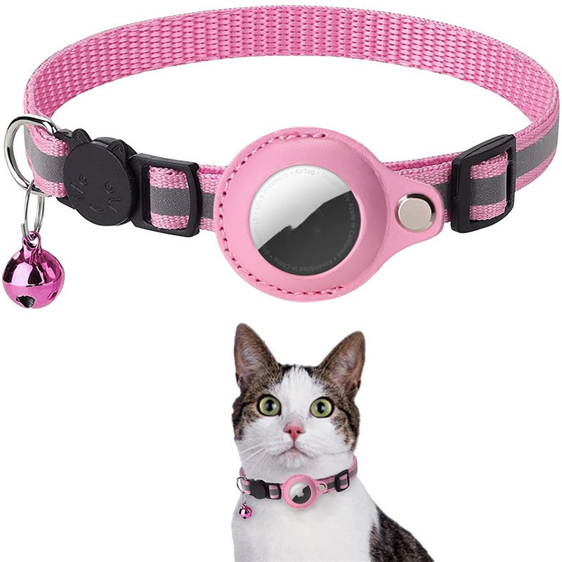 Pink and gray striped cat collar with a bell and reflective patch, worn by a cat.