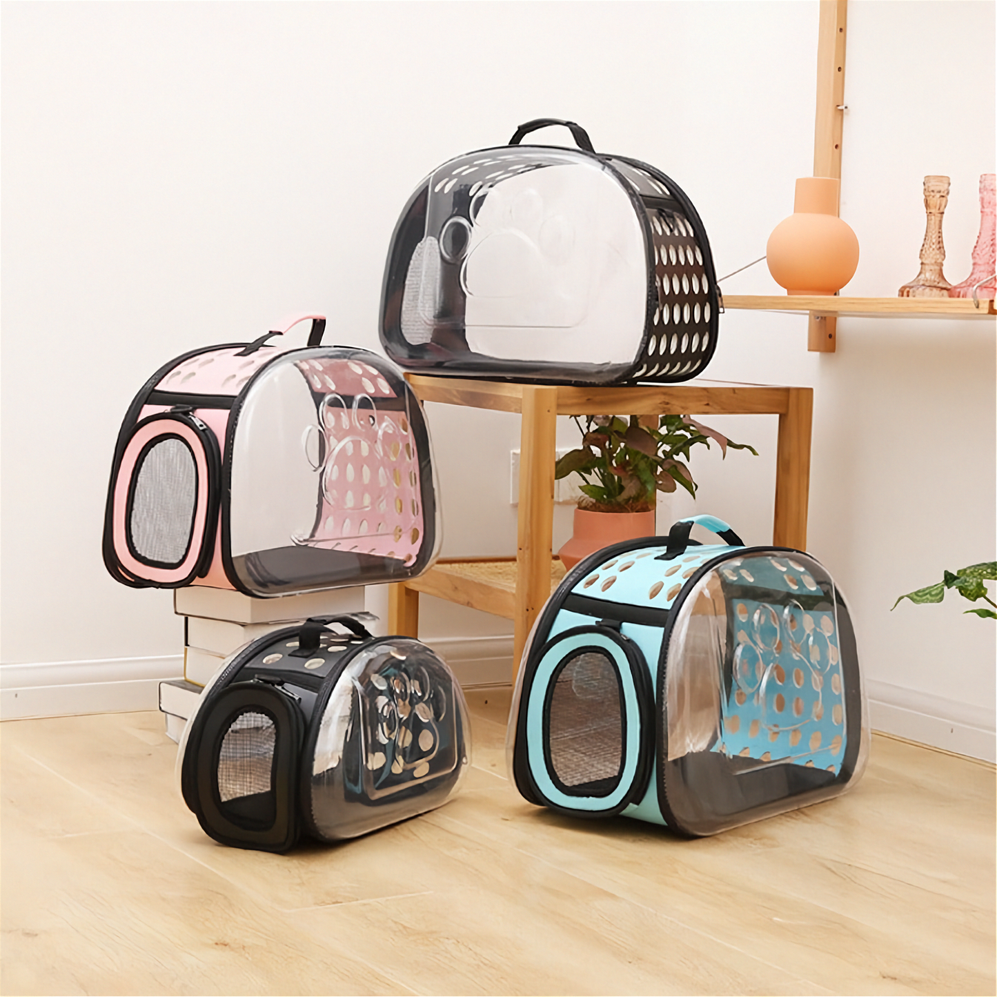 Clear pet carriers with black frames on a wooden floor.