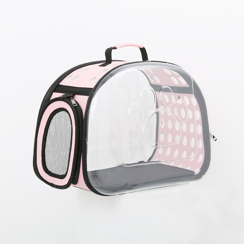 Clear pet carrier with pink polka dot exterior on a white background