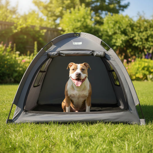 Dog inside a gray pet tent on green grass outdoors